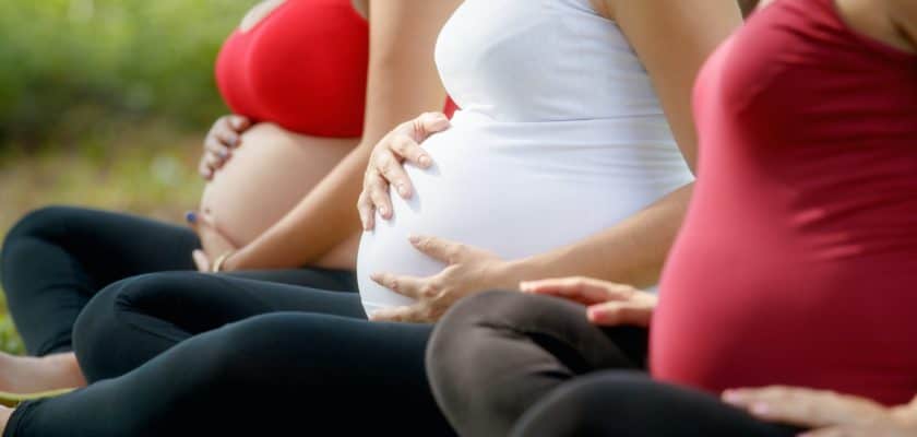 Pregnant Women In Prenatal Class Touching Belly